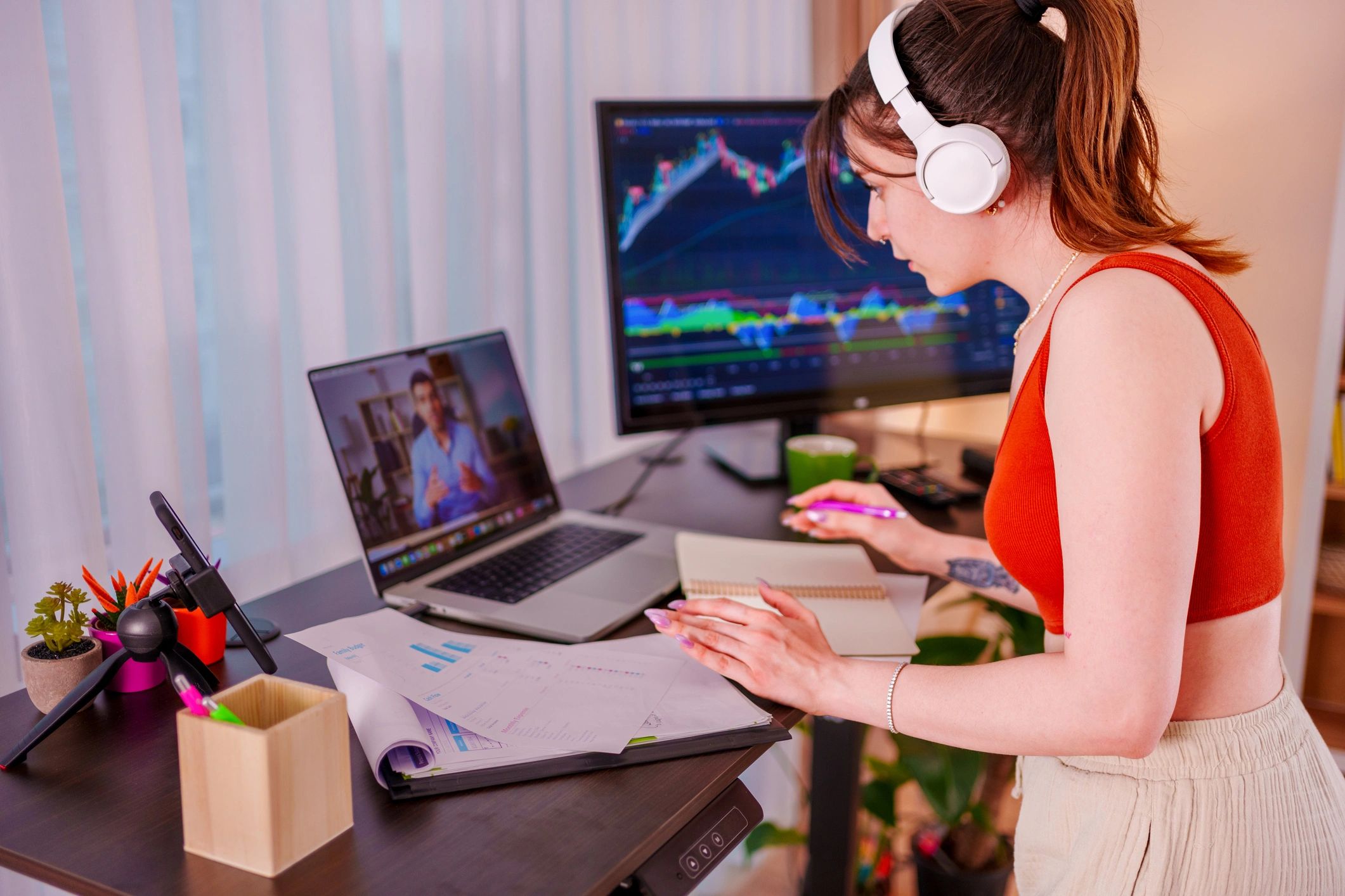 Professional working at a desk with charts on a monitor