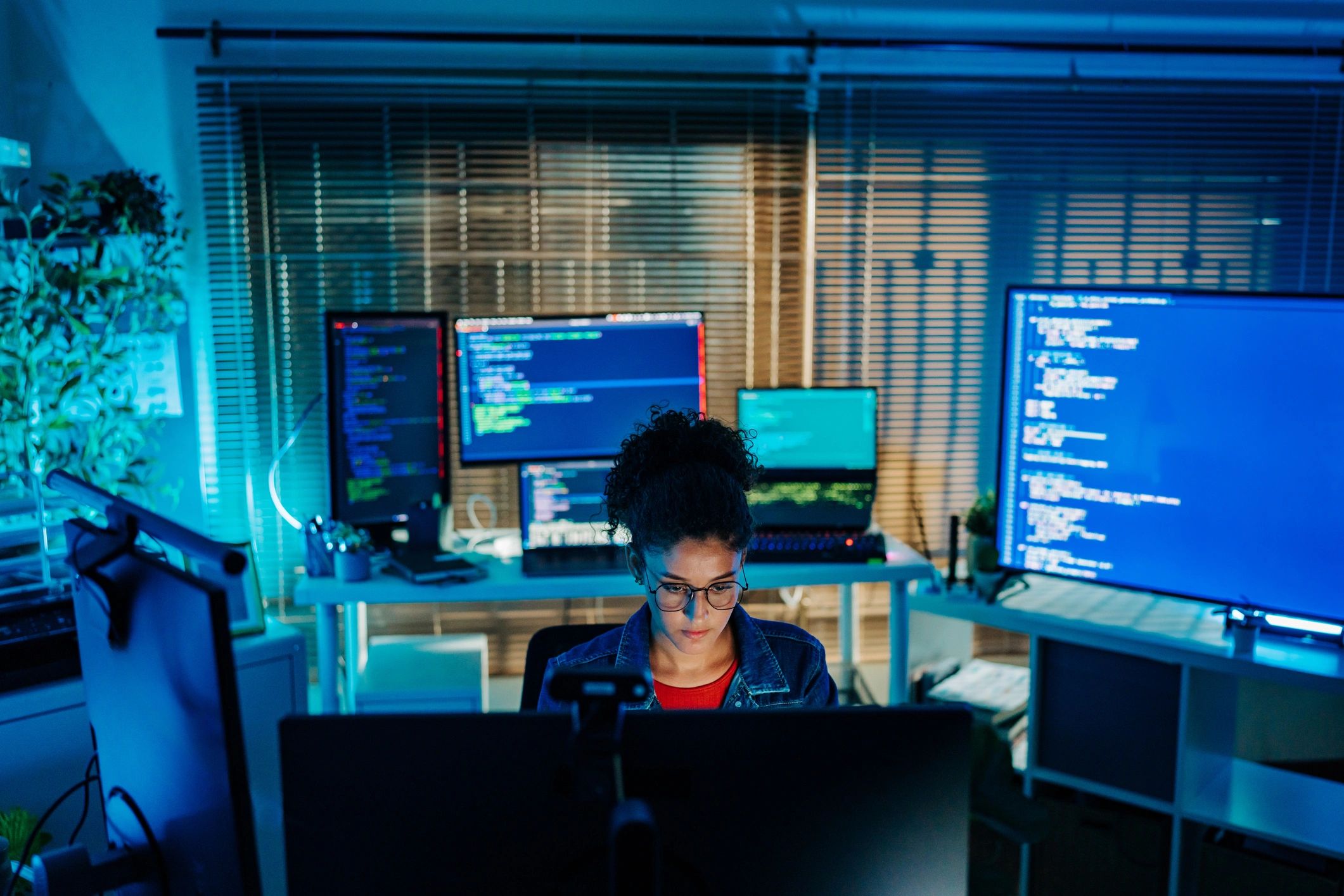 Security operations analyst monitoring multiple screens